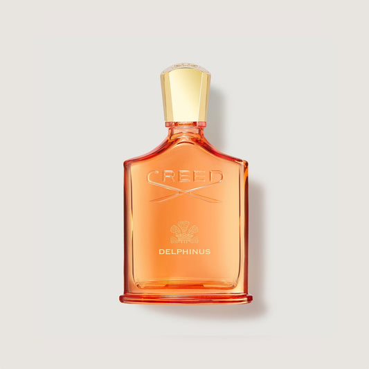 Grande frasco naranja de perfume Creed Delphinus con tapón dorado