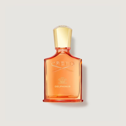 Pequeño frasco naranja de perfume Creed Delphinus con tapón dorado